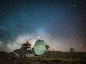 A MAGIC Cherenkov telescope's hexagonal segmented mirror open against the Milky Way, Roque de los Muchachos, La Palma.